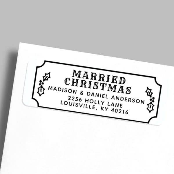 A White Rectangular Return Address Label With Black Text That Reads Married Christmas, Madison &Amp; Daniel Anderson, 2256 Holly Lane, Louisville, Ky 40216. Holly Sprigs Flank The Text.