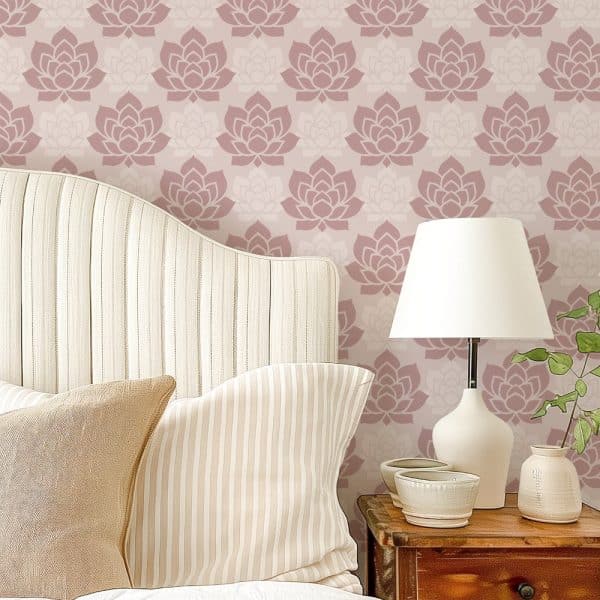 A Bed With Striped Pillows Against A Wall With A Lotus Flower Pattern.