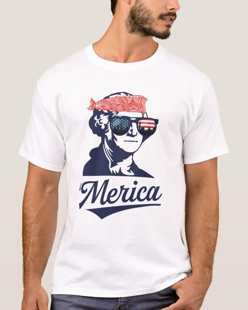 White t-shirt featuring a graphic of George Washington wearing a bandana and American flag sunglasses, with Merica written below.