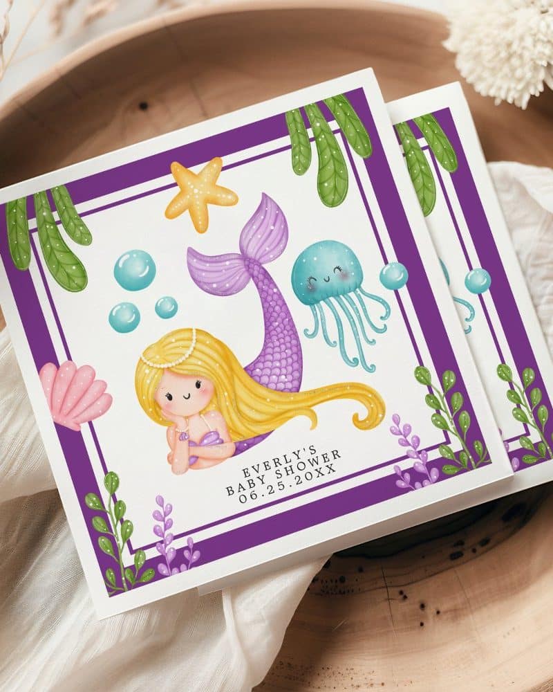 Baby shower invitation featuring a cartoon mermaid with purple tail and blonde hair, surrounded by bubbles, a starfish, and a jellyfish.
