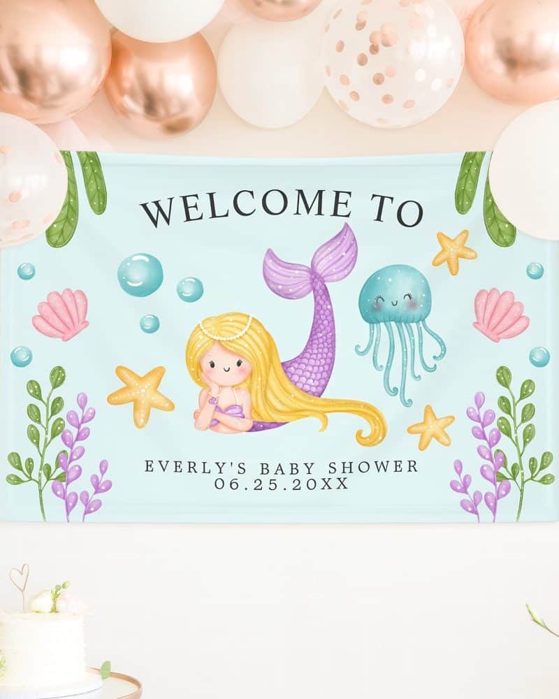 Baby shower banner featuring a mermaid, jellyfish, and seashells on a light blue background. The banner says Welcome to Everly's Baby Shower.