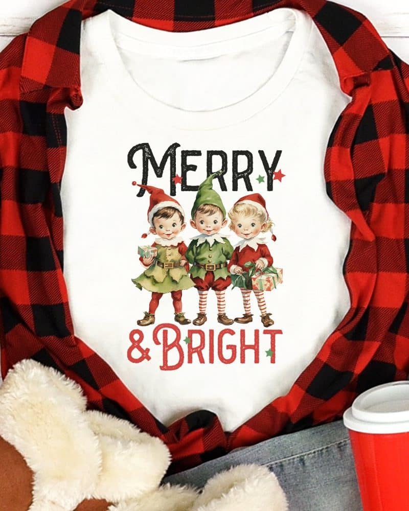 White shirt with three vintage elves holding gifts, text Merry & Bright.