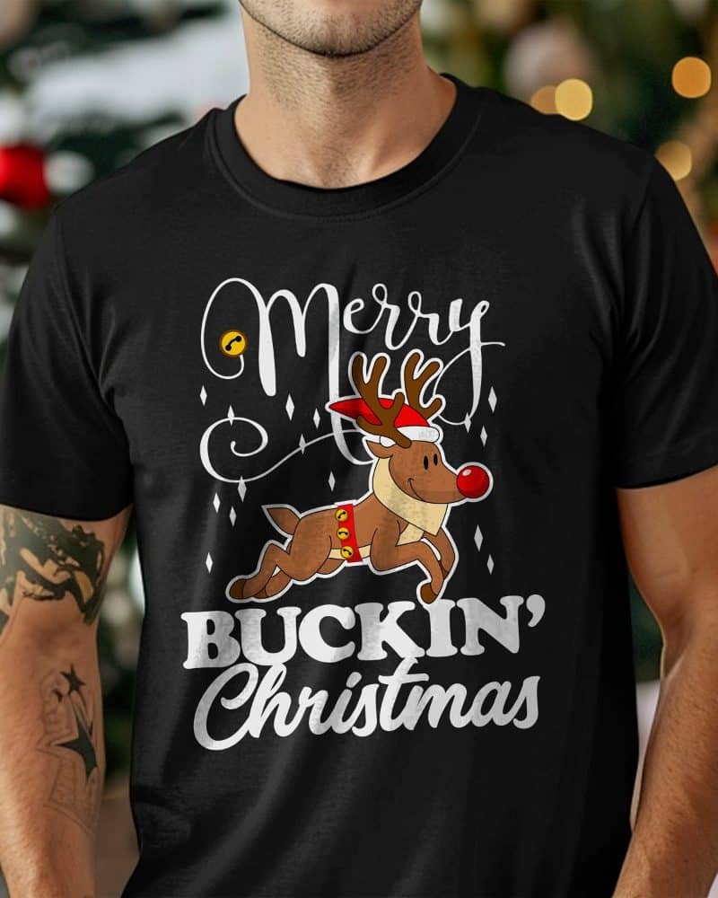 Black t-shirt with a design featuring a reindeer wearing a Santa hat and running, surrounded by the text Merry Buckin Christmas.