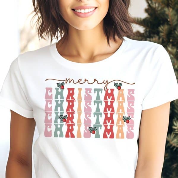White T-Shirt With A Retro-Style Merry Christmas Design In Pastel Colors And Holly Berries.