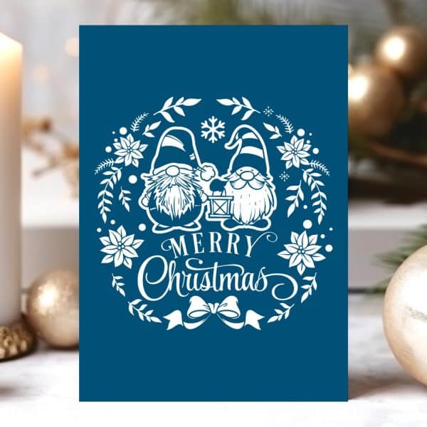 Dark Blue Christmas Card Featuring Two Gnomes Holding A Lantern In A White Floral Wreath With Merry Christmas Text.