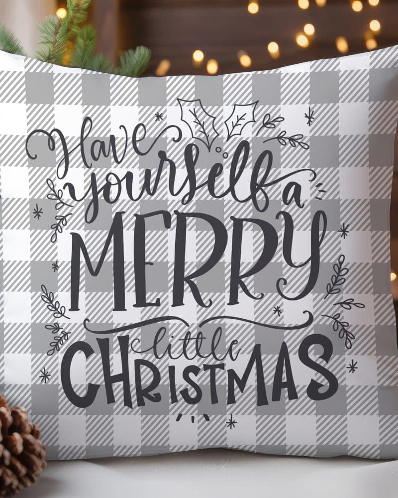 Gray and white checkered Christmas pillow with the text Have Yourself a Merry Little Christmas.