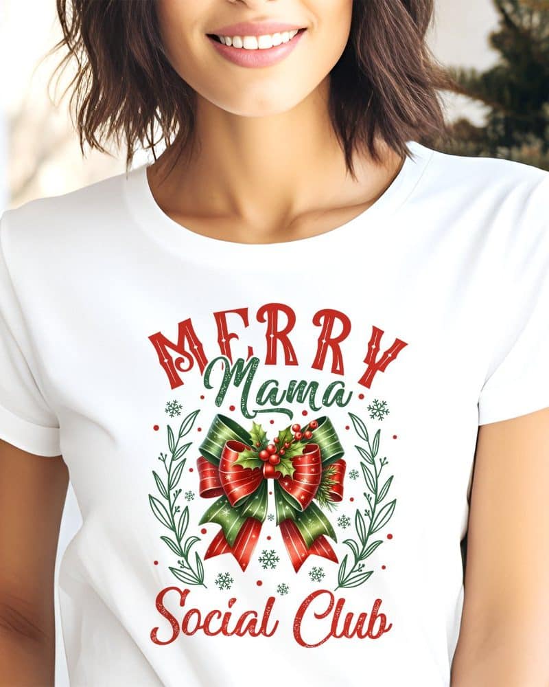 White t-shirt with a Christmas design featuring a red and green bow, snowflakes, and the text Merry Mama Social Club.