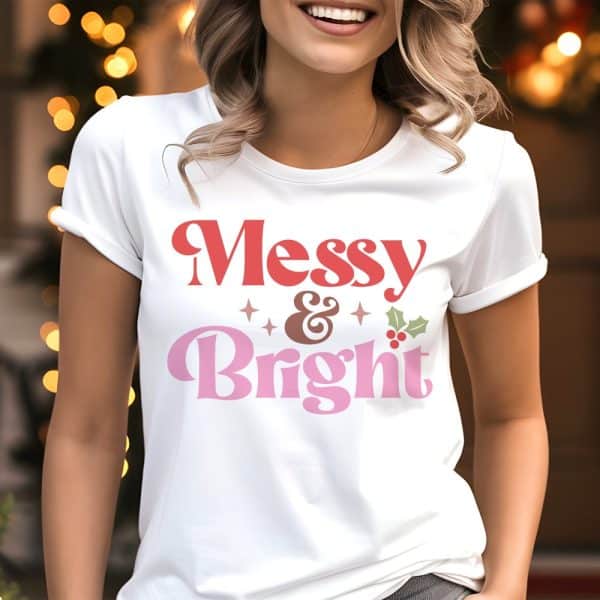 Woman Wearing A White T-Shirt With A Christmas Design That Says Messy &Amp; Bright In Retro Style Lettering.