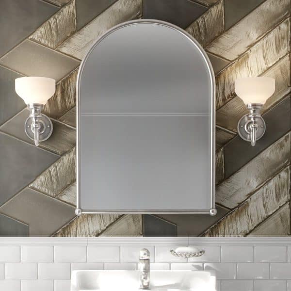 Arch-Shaped Bathroom Mirror With Flanking Lights, Mounted On A Herringbone Patterned Wall.