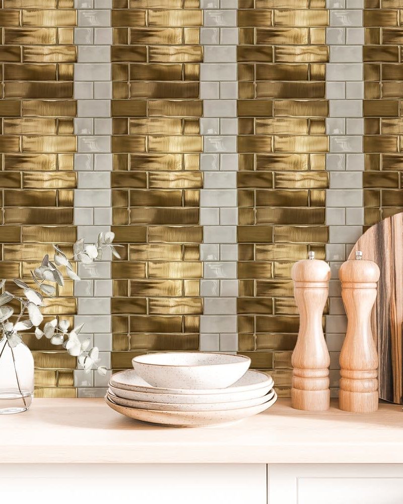 Gold and white brick tile backsplash with kitchen counter items.
