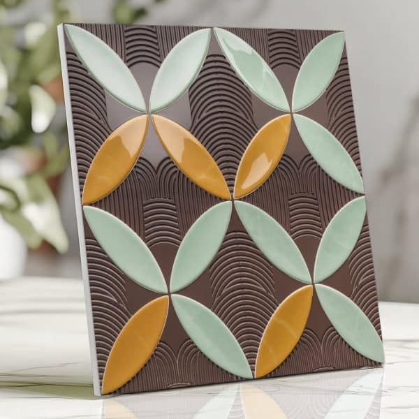 Square Tile With A Repeating Pattern Of Overlapping, Stylized Flower Shapes In Shades Of Green And Gold On A Brown Background.