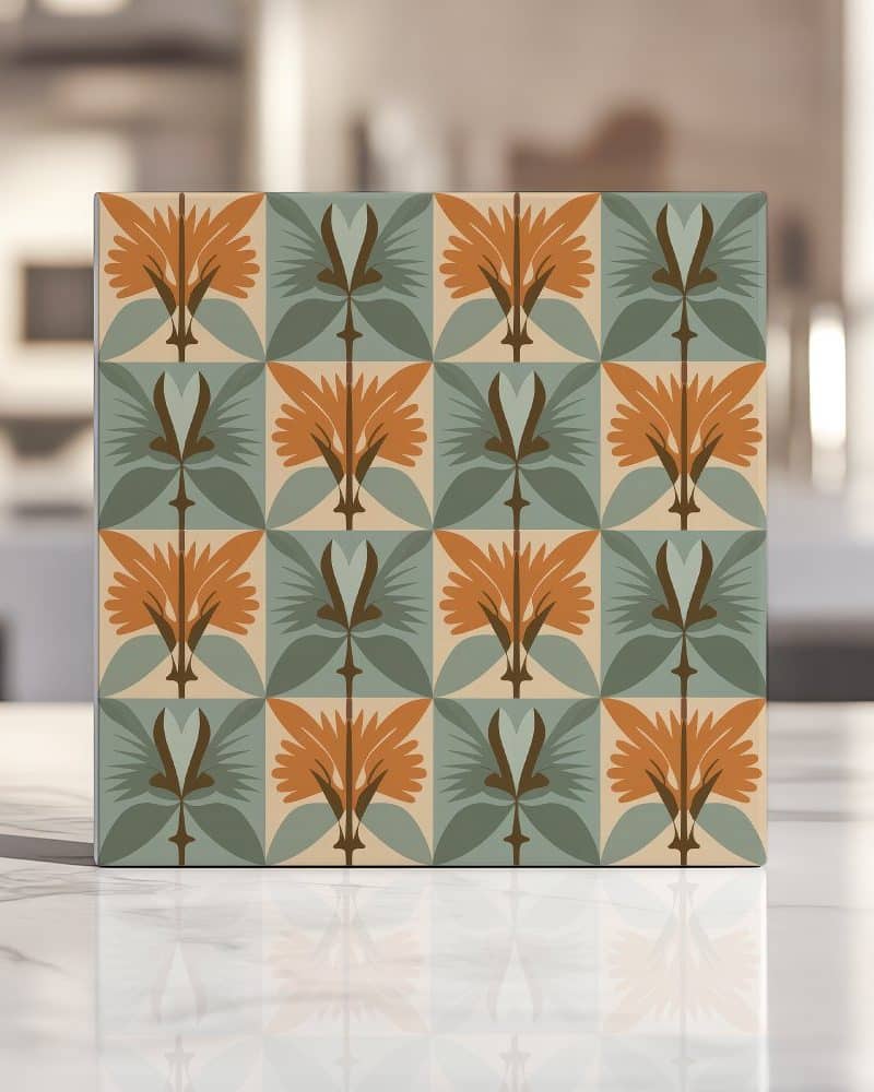 Square tile with repeating geometric floral pattern in orange, green, and beige.