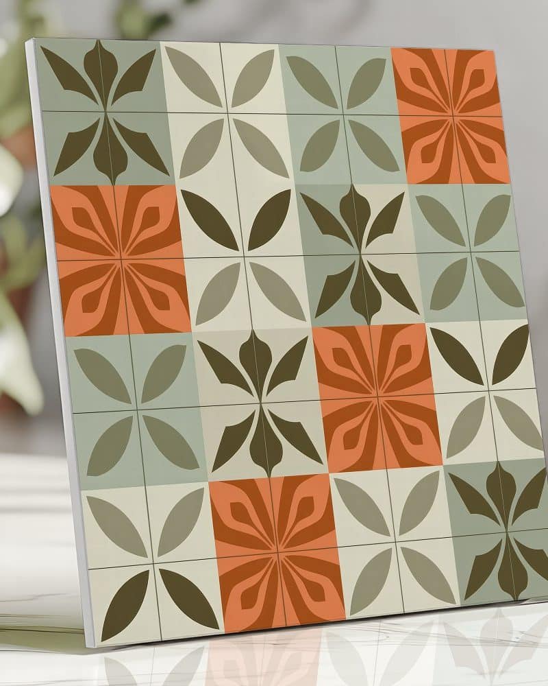 Square tile design featuring a repeating pattern of stylized flowers in shades of orange, green, and brown.