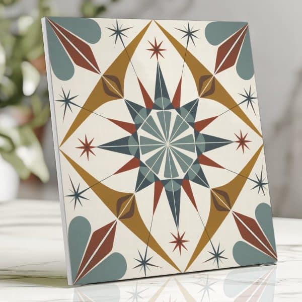 A Square Tile With A Geometric, Starburst Design In Teal, Mustard Yellow, And Burnt Orange.