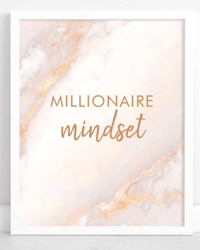 White framed print featuring a pink marble texture with gold accents and the text Millionaire Mindset in copper lettering.