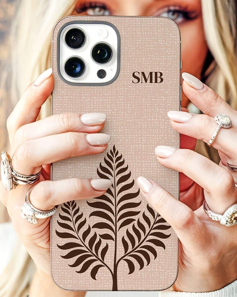 Beige phone case with a brown fern design and initials SMB.