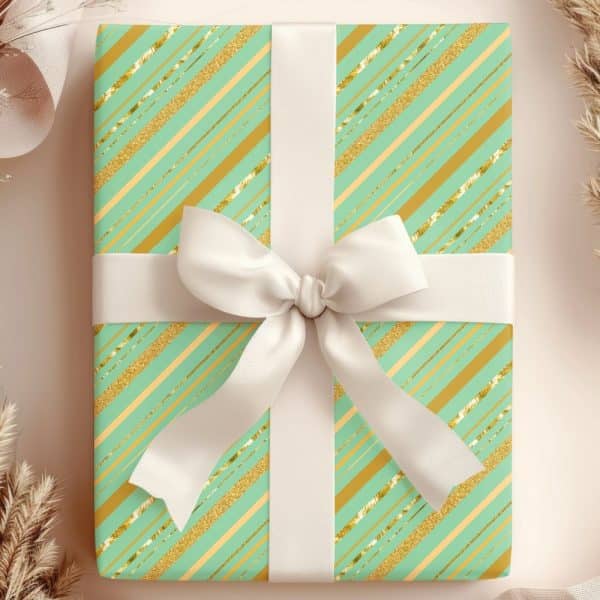 A Mint Green And Gold Gift Box With A White Ribbon.