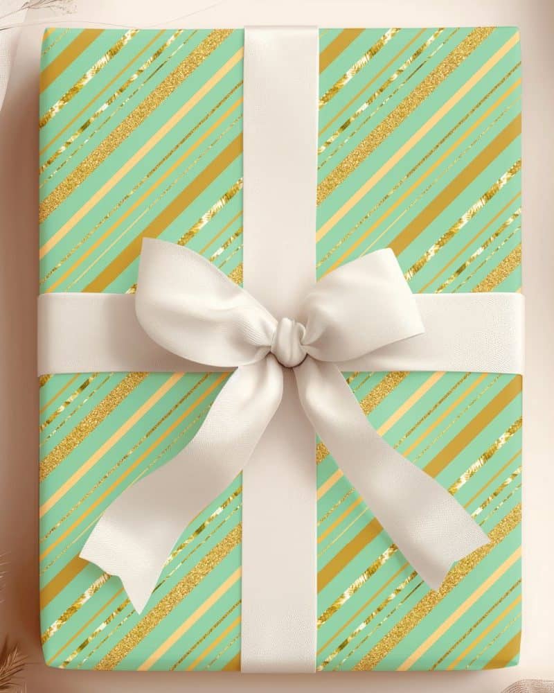 A mint green and gold gift box with a white ribbon.