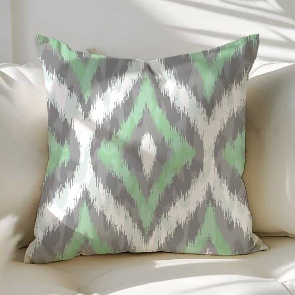 Decorative Throw Pillow With A Green And Gray Ikat Pattern.