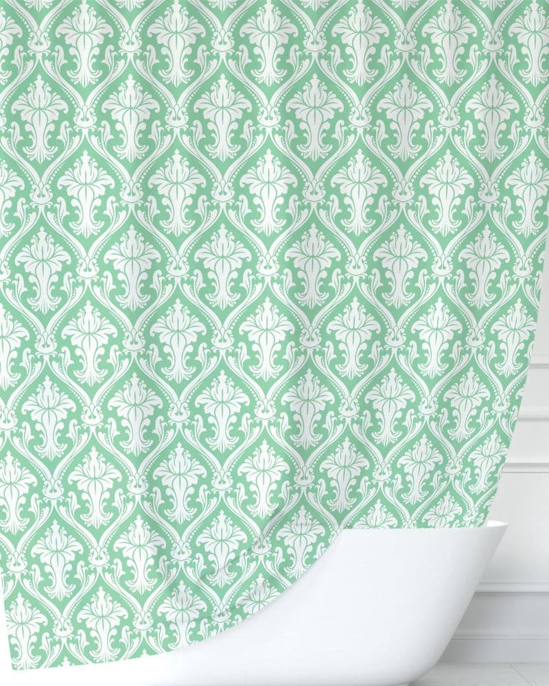 Mint green shower curtain with a white damask pattern.
