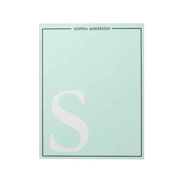 Light Green Notepad With A Large White Letter S And A Name At The Top.