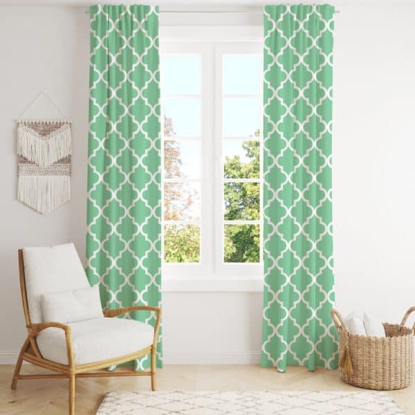 Light Green Curtains With A Quatrefoil Pattern Hang In Front Of A Window.