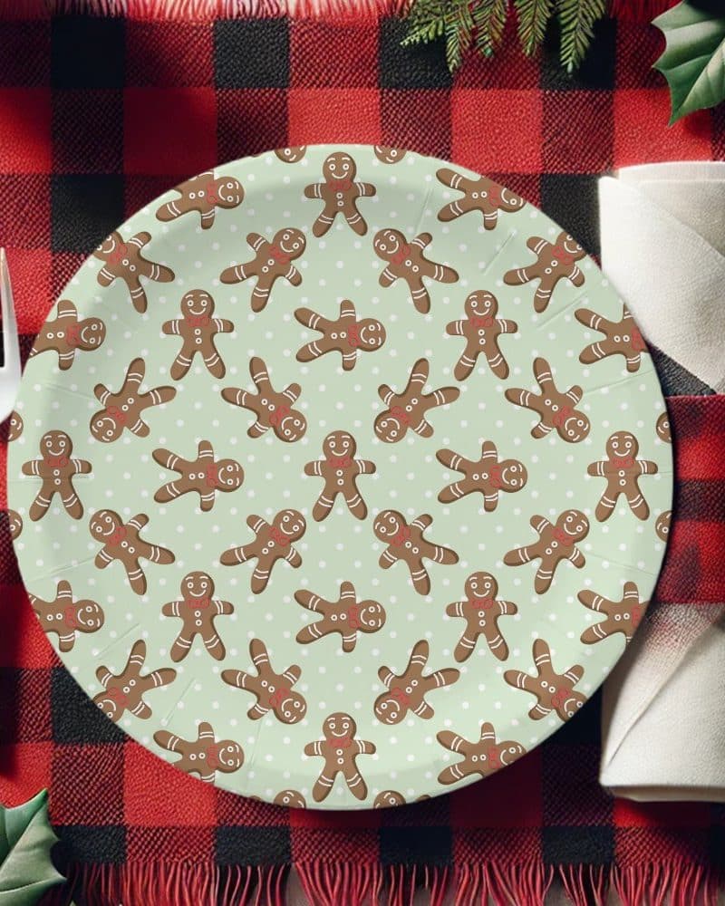Paper plate with a pattern of gingerbread men on a light green background.