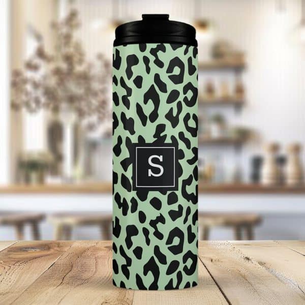 Sage Green Travel Tumbler With A Black Leopard Print And A Black Square Featuring The Letter S In The Center.