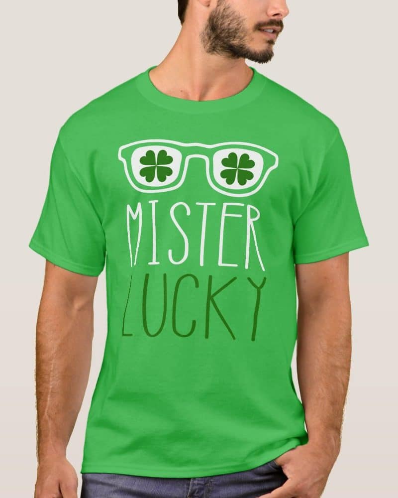 Man wearing a bright green t-shirt with shamrocks forming sunglasses and the words Mister Lucky.