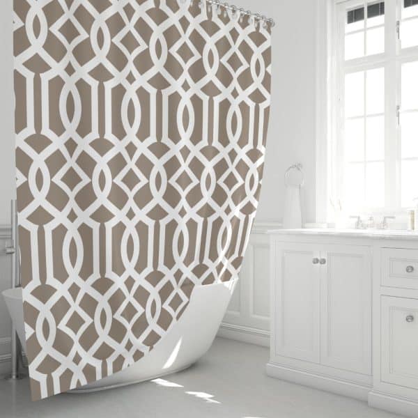 Beige And White Geometric Patterned Shower Curtain Partially Draped Over A White Bathtub.