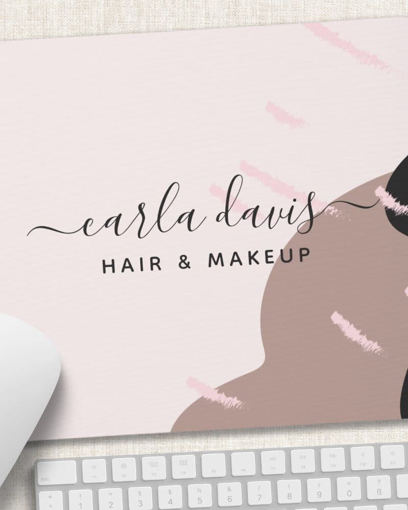 Mousepad featuring Carla Davis Hair & Makeup logo with abstract shapes and brushstrokes in pink, brown, and black.