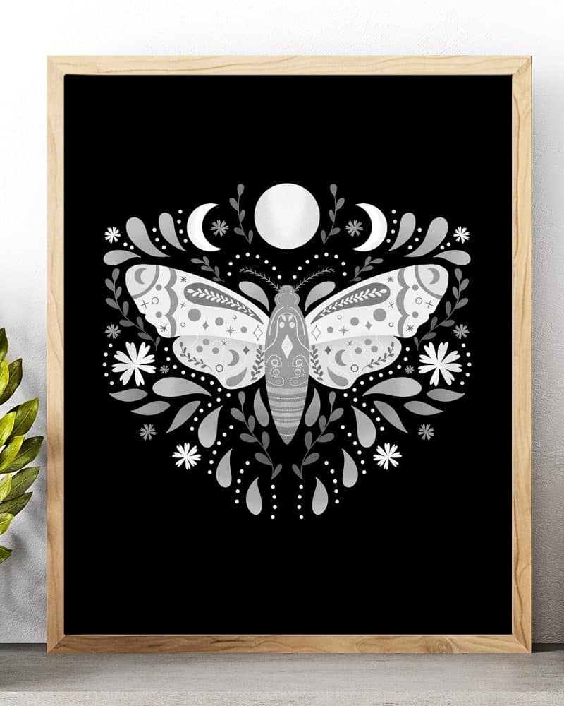 Silver moth illustration on black background, surrounded by floral designs and moons.