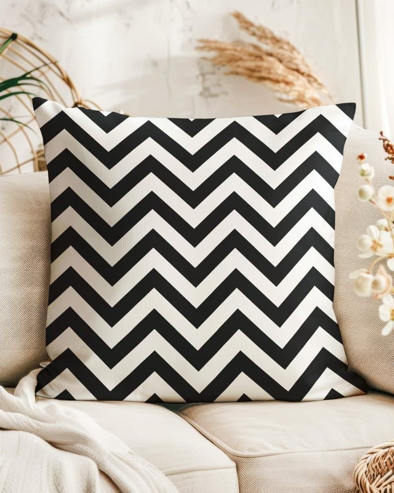 Black and white chevron patterned throw pillow on a beige couch.