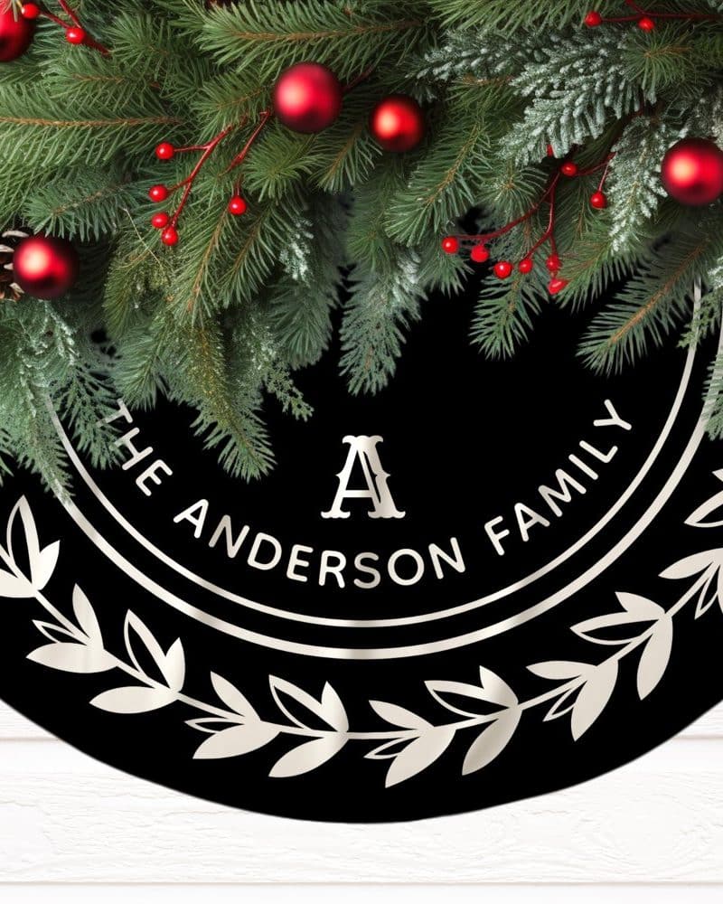 Black Christmas tree skirt with silver wreath and personalized Anderson family text.