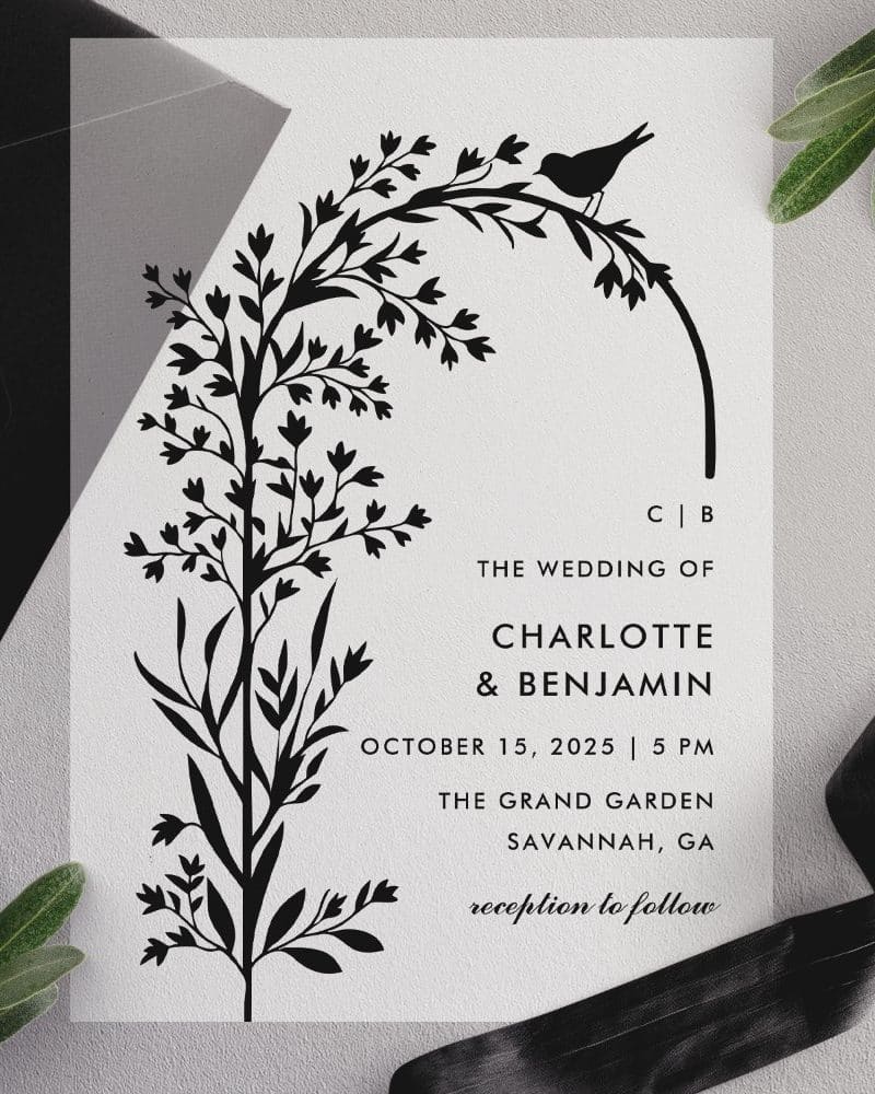 Wedding invitation with black floral illustration and bird.