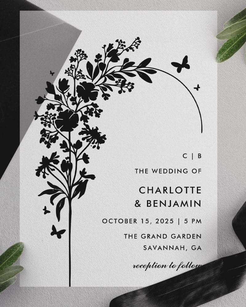Black and white wedding invitation with floral illustration.