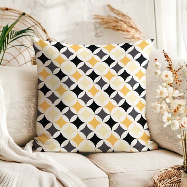 Decorative Pillow With A Geometric Pattern In Yellow, Black, And Gray.