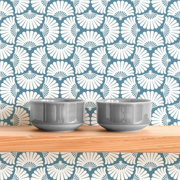 Two Gray Bowls Sit On A Wooden Shelf Against A Wall With A White And Blue Fan-Shaped Pattern.