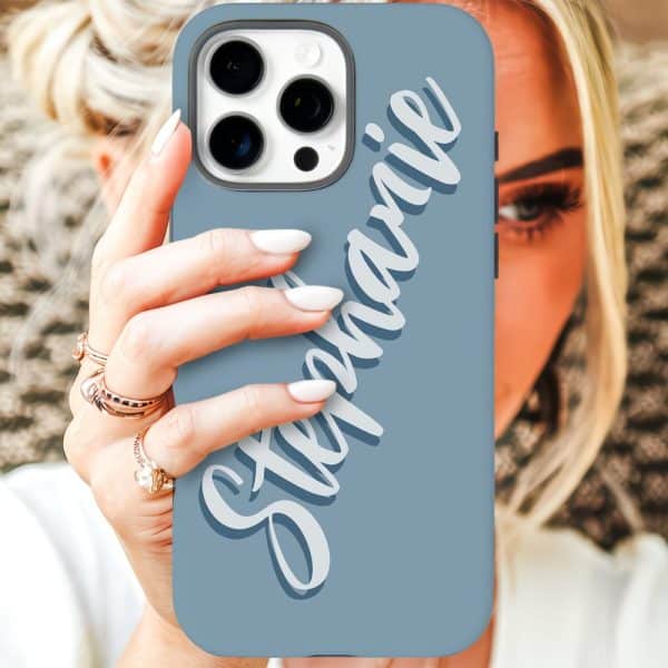 A Woman'S Hand Holds A Light Blue Iphone Case With The Name Stephanie In Stylized White Lettering.