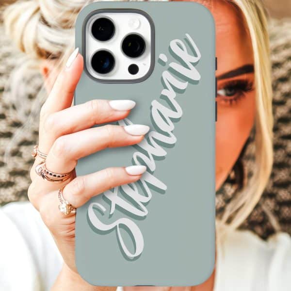 A Woman'S Hand Holds A Light Teal Iphone Case With The Name Stephanie Written In Stylized White Lettering.