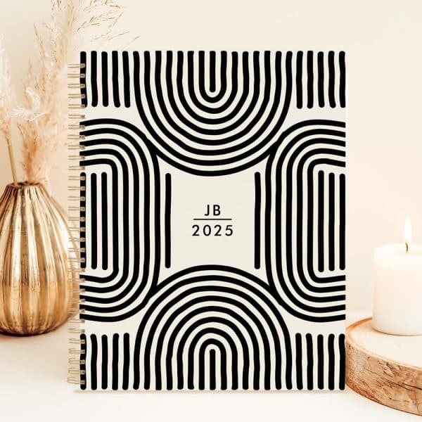 2025 Spiral-Bound Planner With A Black And Cream Abstract Design.