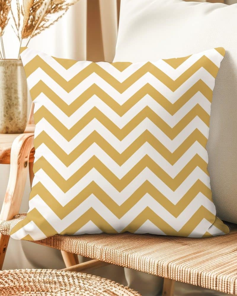 Gold and white chevron patterned throw pillow.