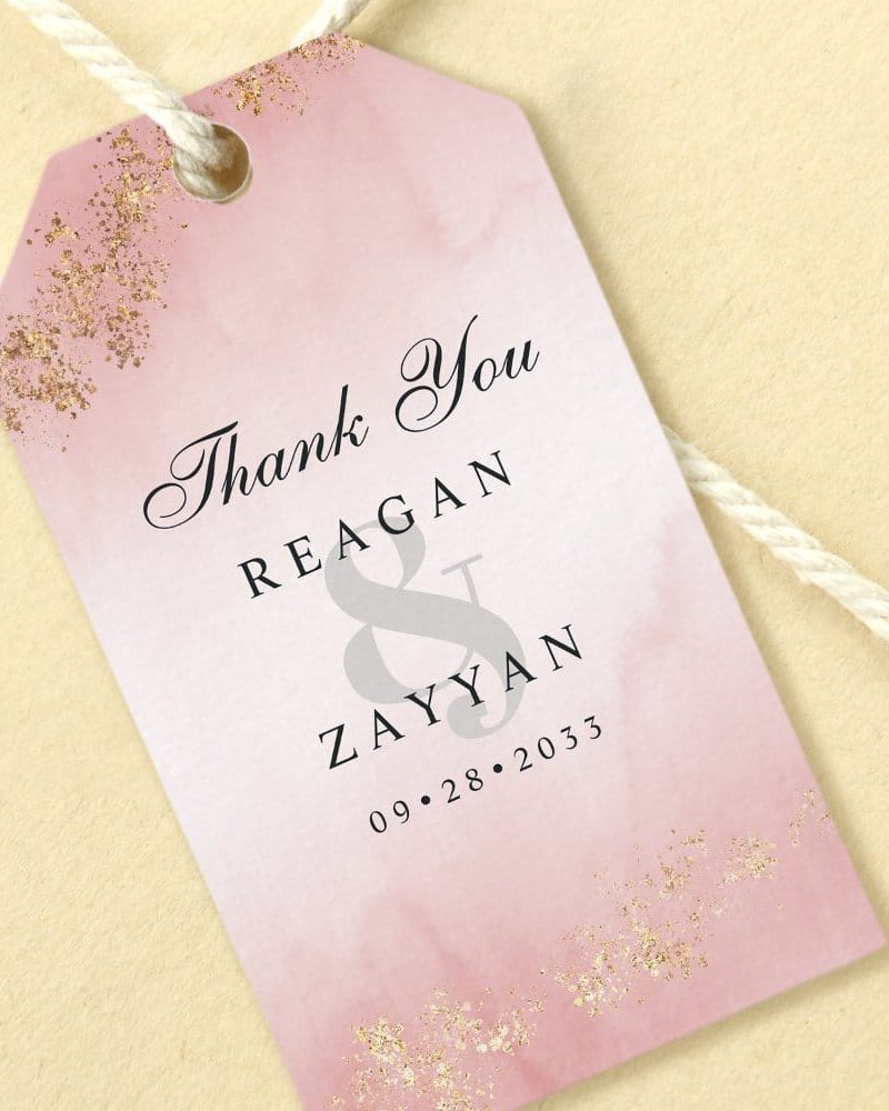 Pink wedding thank you tag with gold accents, featuring the names Reagan & Zayyan and the date 09.28.2033.