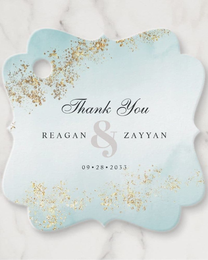 Light blue thank you tag with gold accents, featuring the names Reagan & Zayyan and the date 09.28.2033.