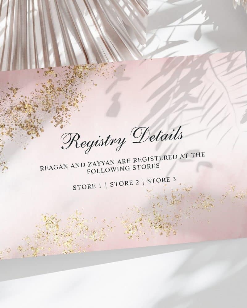 Pink registry card with gold accents listing Reagan and Zayyan's store locations.