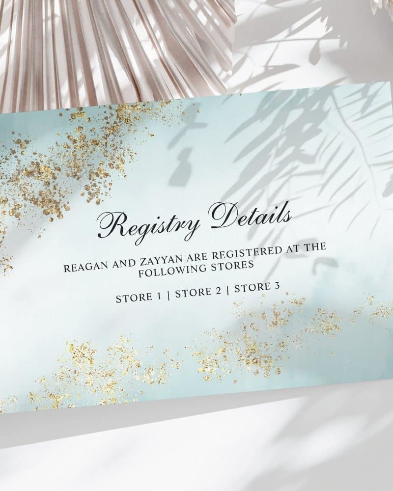Light blue registry card with gold accents, listing Reagan and Zayyan's registry information at three stores.