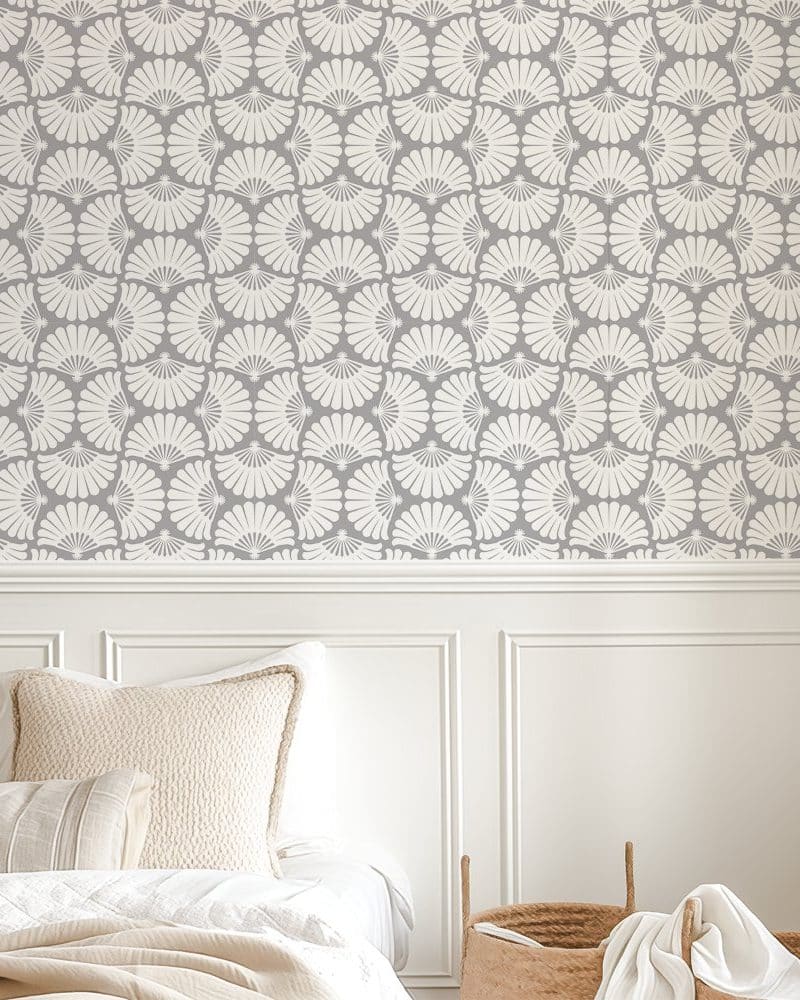 Grey wallpaper with a repeating pattern of off-white stylized fans.