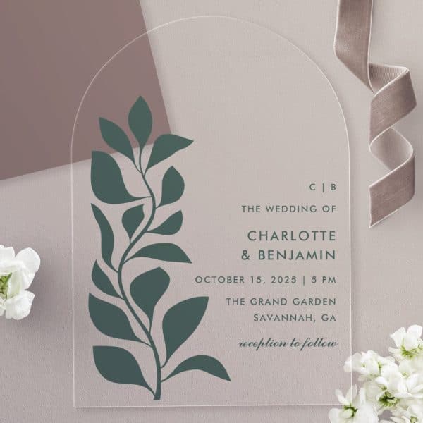 Arch-Shaped Clear Acrylic Wedding Invitation With A Dark Green Stylized Floral Design And The Names Charlotte And Benjamin.