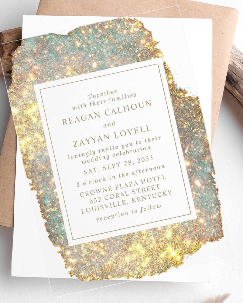 Wedding invitation with gold and teal glitter design; Reagan Calhoun and Zayyan Lovell's wedding details are featured.