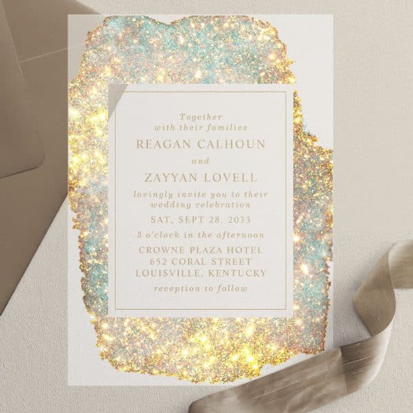Wedding Invitation For Reagan Calhoun And Zayyan Lovell, September 28, 2033, At The Crowne Plaza Hotel In Louisville, Kentucky. The Invitation Features A Sparkly Gold And Teal Design.